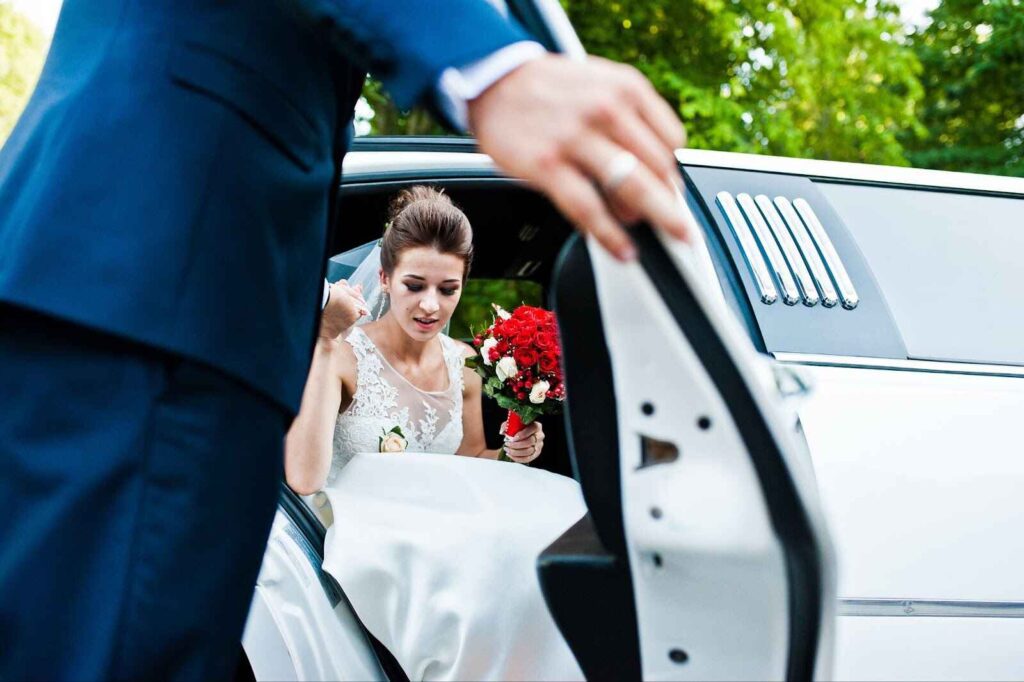 Bride and groom stepping out of a limousine at a Houston wedding venue.